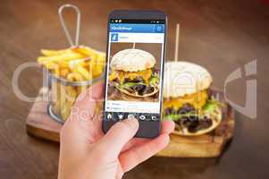 Composite image of female hand holding a smartphone