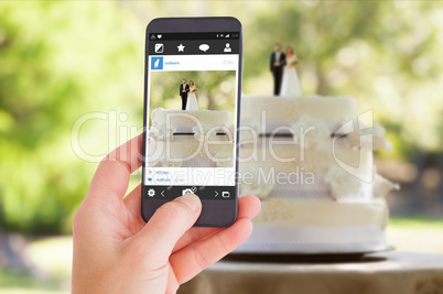 Composite image of female hand holding a smartphone