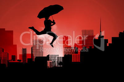 Composite image of woman jumping with umbrella