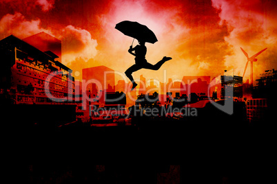 Composite image of woman jumping with umbrella