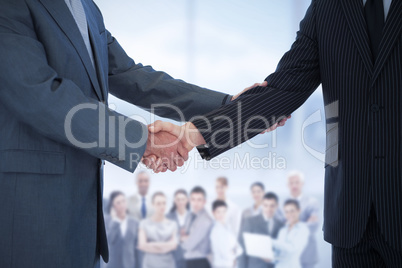 Composite image of handshake in agreement