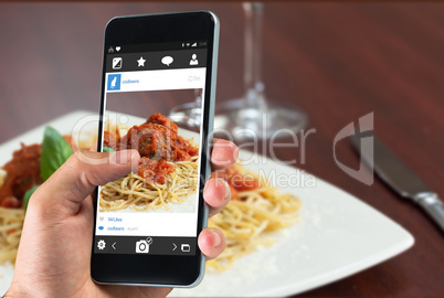 Composite image of hand holding smartphone