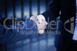 Composite image of businessmen shaking hands