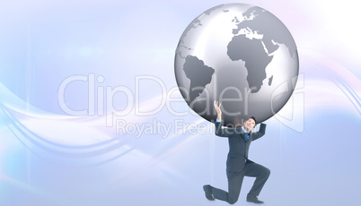 Composite image of businessman carrying the world