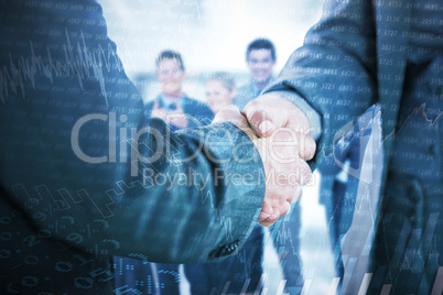 Composite image of business people shaking hands close up