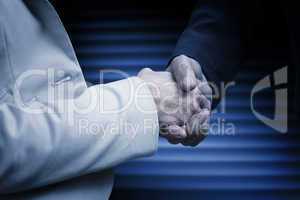 Composite image of business people shaking hands