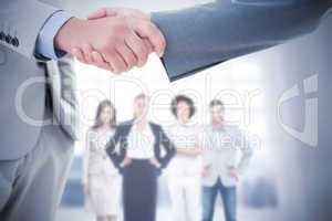 Composite image of business handshake