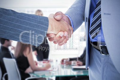 Composite image of  businessman shaking hands with a co worker