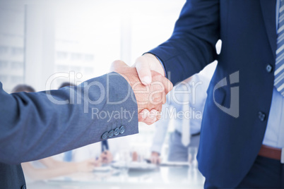 Composite image of businessmen shaking hands