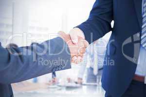 Composite image of businessmen shaking hands