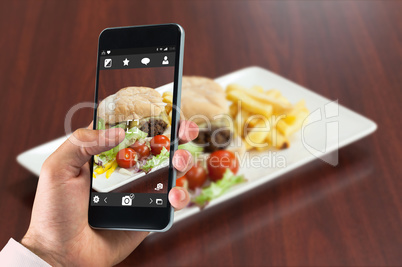 Composite image of hand holding smartphone