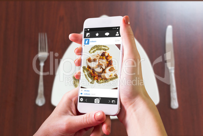 Composite image of hand holding smartphone