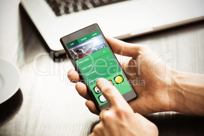 Composite image of hand holding smartphone Composite image of hand holding smartphone