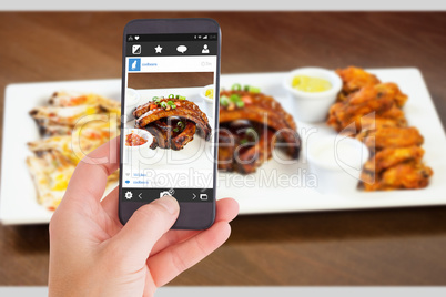 Composite image of female hand holding a smartphone