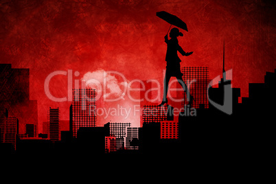 Composite image of businesswoman stepping with umbrella