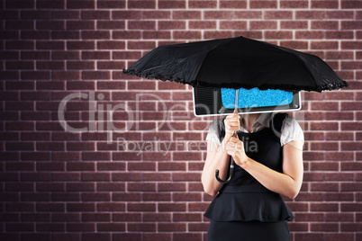 Composite image of pretty redhead businesswoman holding umbrella