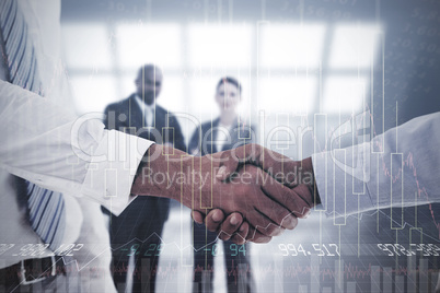 Composite image of close-up shot of a handshake in office