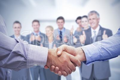 Composite image of men shaking hands