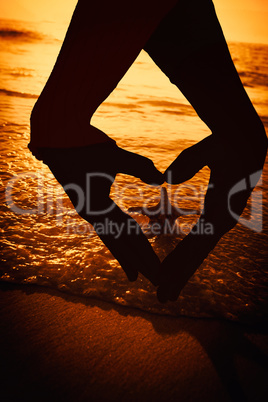 Composite image of close up of hands forming heart