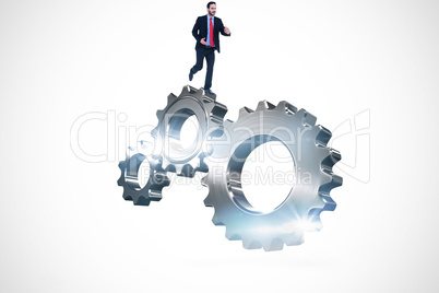 Composite image of smiling young businessman in suit running