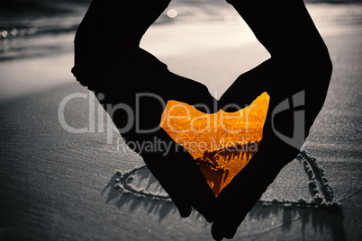 Composite image of close up of hands forming heart Composite image of close up of hands forming heart