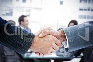 Composite image of business people shaking hands