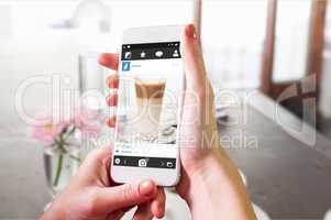 Composite image of hand holding smartphone