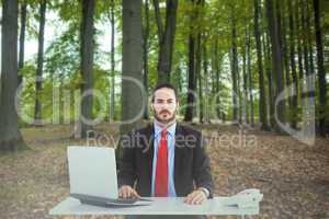 Composite image of unsmiling businessman sitting at desk
