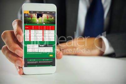 Composite image of businessman using smartphone Composite image of businessman using smartphone