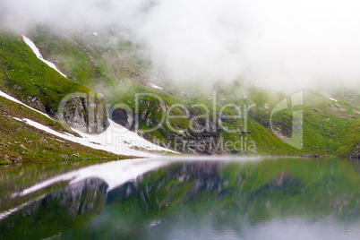 Idyllic view with typical lodges on Balea Lake shore