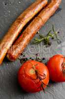 Grilled tomatoes with sausages
