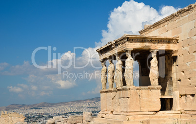 Caryatids portico on Acropolis and Athens view.