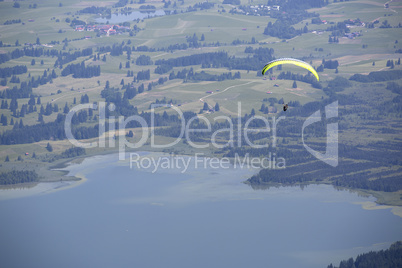 Paraglider flying over Bavarian lake
