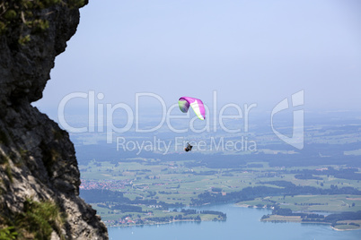 Paraglider flying over Bavarian lake Forggensee