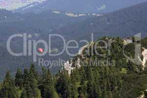 Paraglider flying over Bavarian mountains