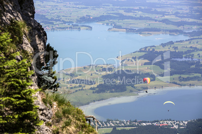 Paragliders flying over Bavarian lake Forggensee