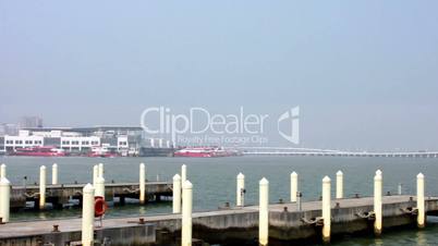 Mooring posts at Macau Fisherman's Wharf and view of Outer Harbour Ferry Terminal