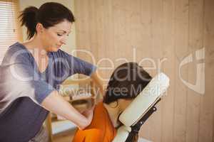 Young woman getting massage in chair