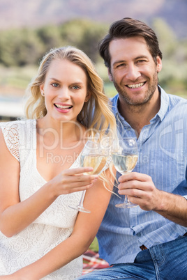 Couple on date toasting with glass of white wine