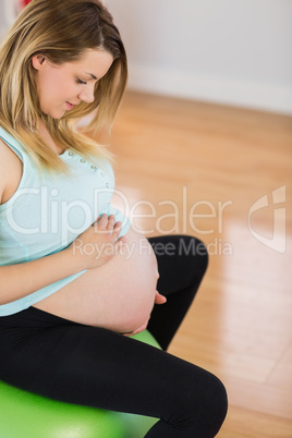 Pregnant woman sitting on exercise ball