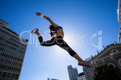 Athletic woman jumping in the air
