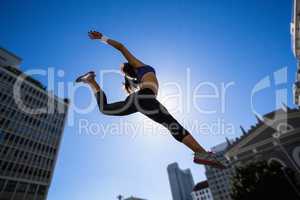 Athletic woman jumping in the air
