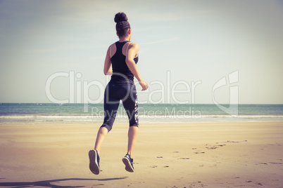 Fit woman jogging on the sand