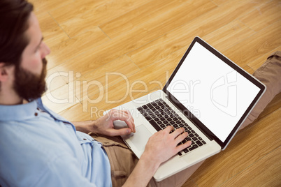 Handsome hipster using his laptop