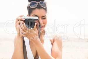 Pretty hipster in bikini taking picture