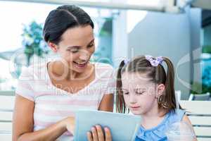 Mother and daughter using tablet computer together