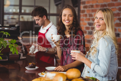 Female friends having coffee at coffee shop