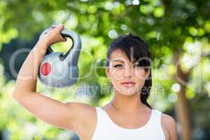 Portrait of athletic woman lifting kettlebell