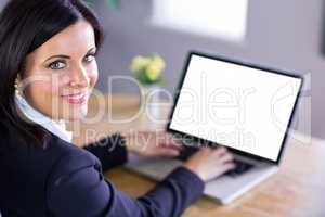 Businesswoman working at her desk on laptop