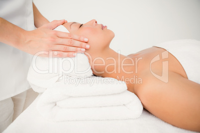 Attractive young woman receiving facial massage